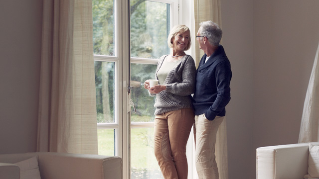 Older couple standing by the window - Small