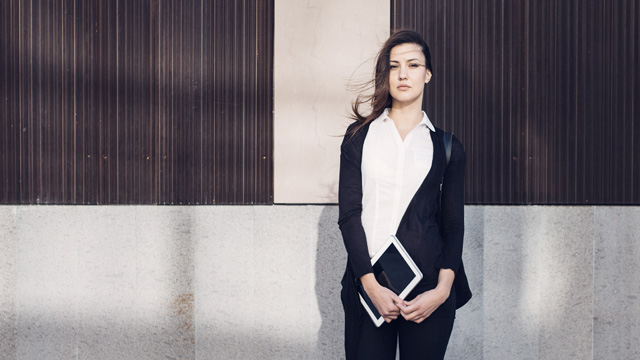 Woman standing outside with a pad